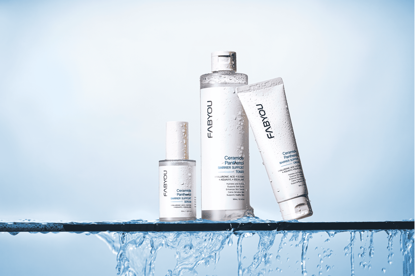 Ceramide Panthenol Barrier Support Line by FABYOU featuring toner, serum, and cream on a water-splashed surface with light blue background